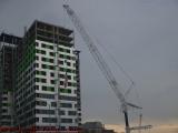 Crane With Flag at Construction Under Clouds, E. Cambridge