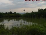 Pond and Windmill Under Clouds, Groveland, New York