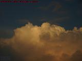 Jet Nearly Lost in the Face of Billowing Sunset Clouds