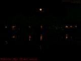 Orange Full Moon Rising Over St. Tropez Apartments