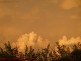 Cloud Army Advancing West Under Sunset-Lit Sky